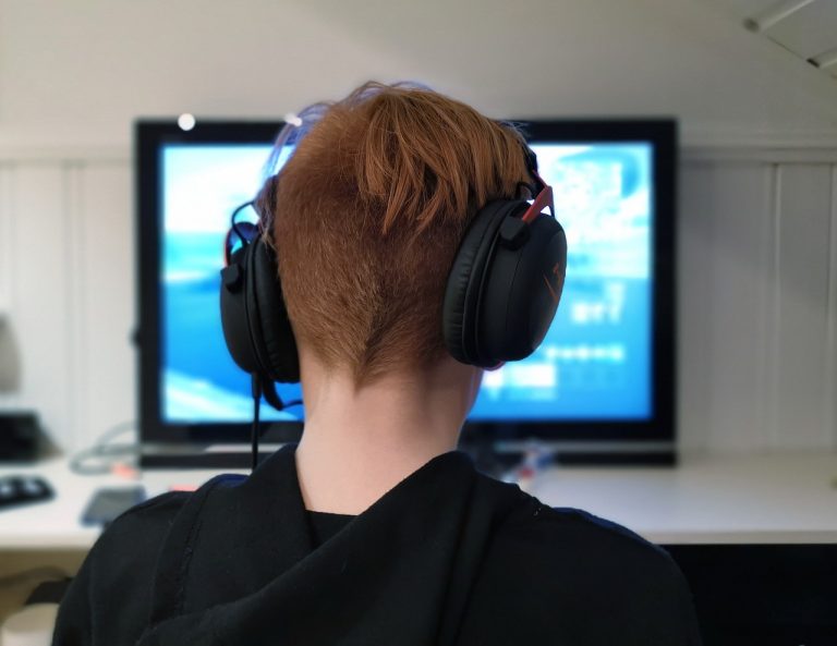 A child is sitting at the corner and playing game